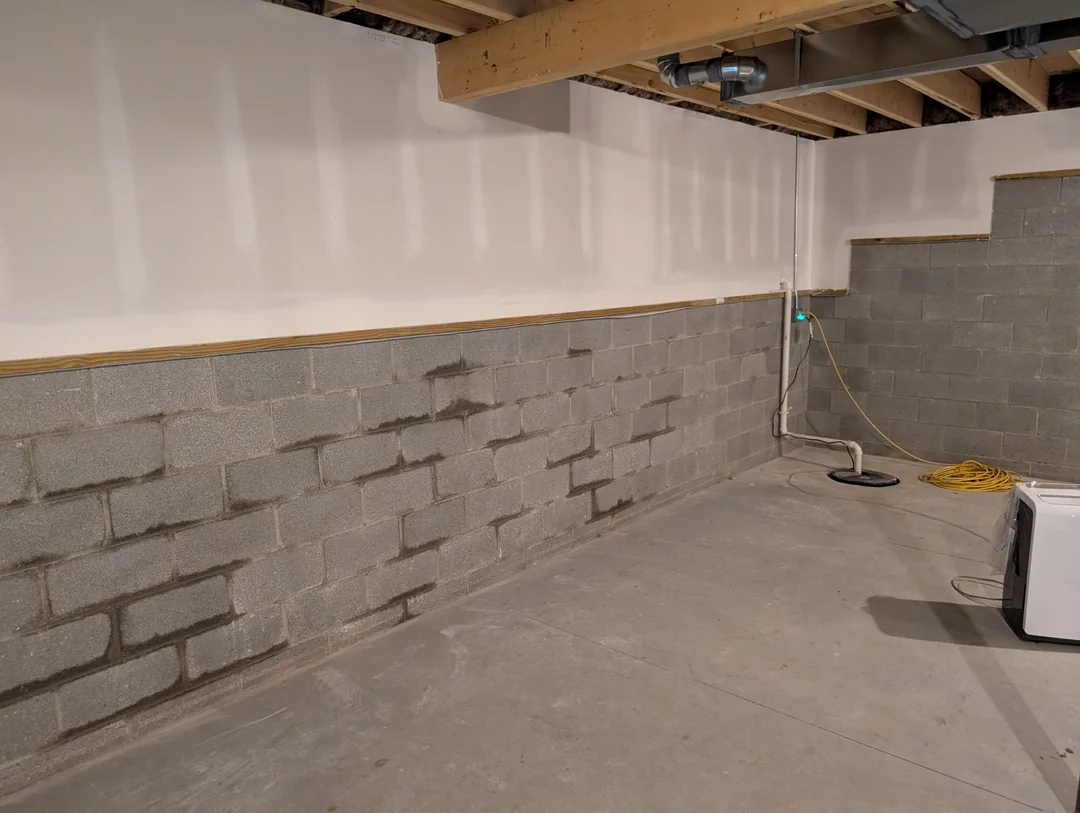 A Portland basement wall showing water stains, the kind of problem basement waterproofing fixes