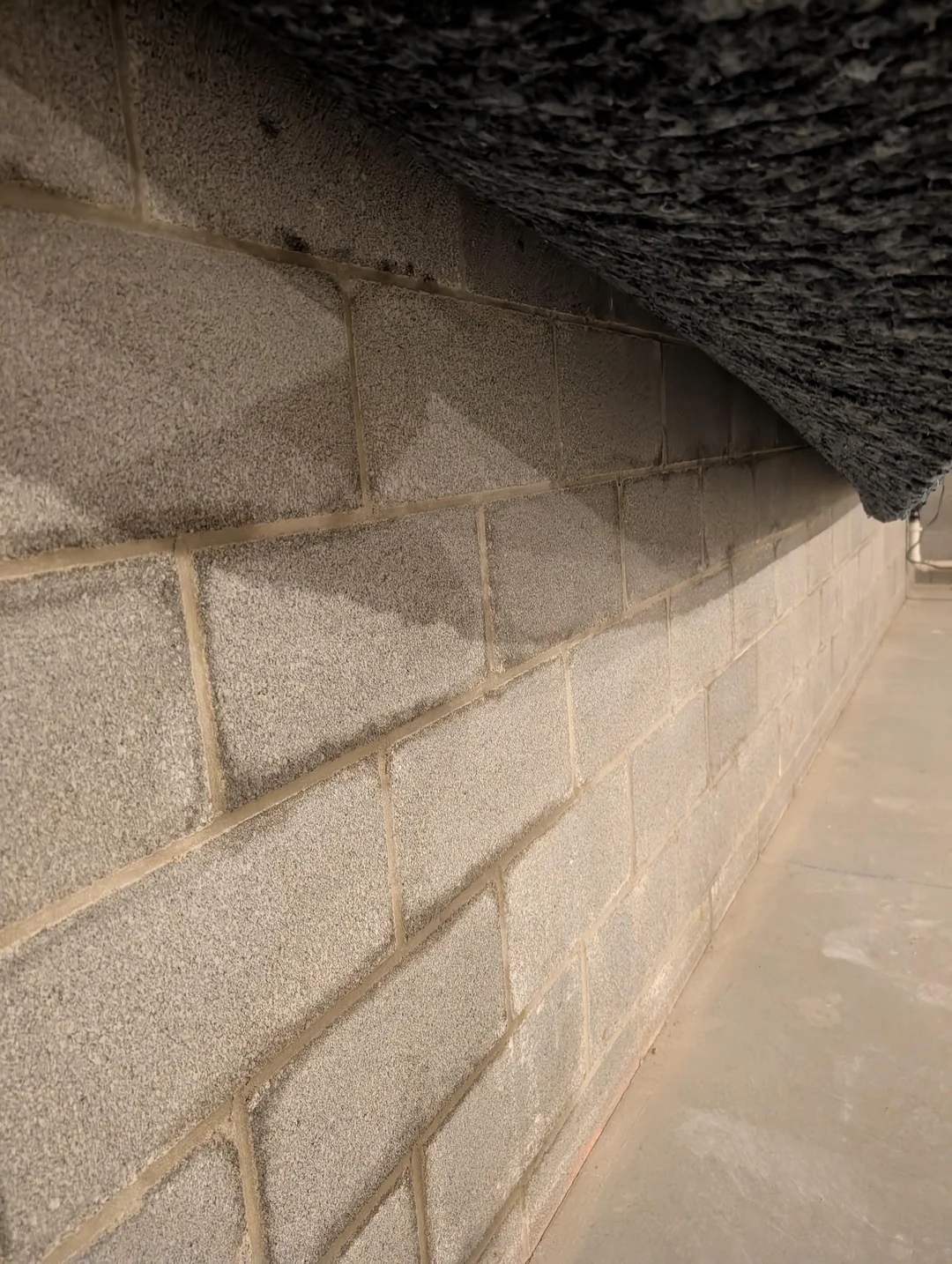 Crawl space wall inspected before encapsulation by Basement Waterproofing Portland