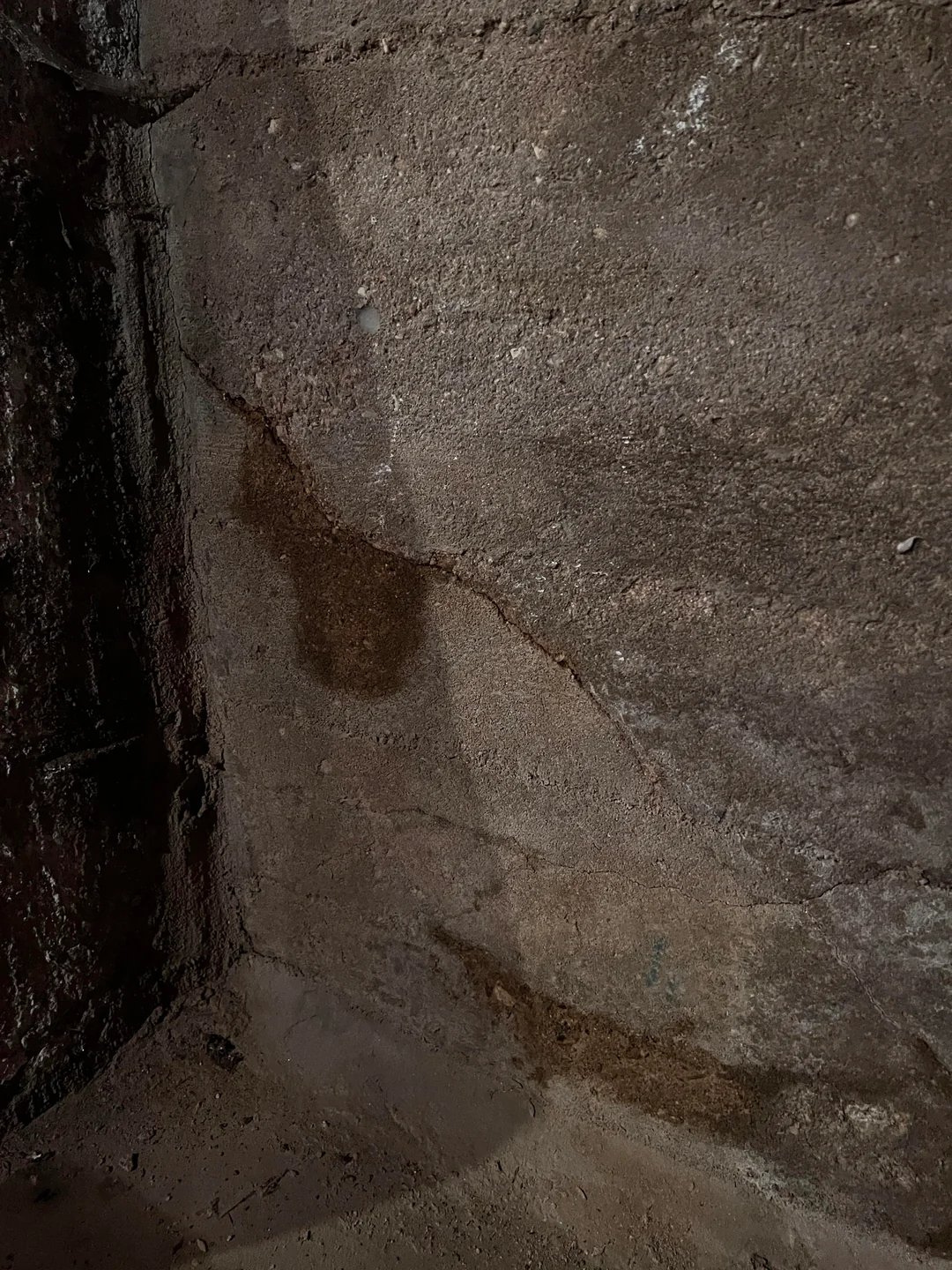 Basement waterproofing Portland crew assessing a foundation crack before resin injection