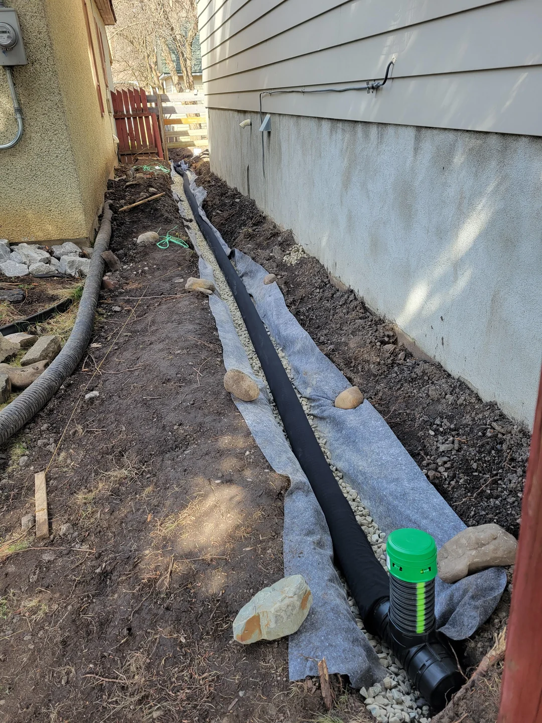 Exterior foundation waterproofing membrane and drain board installed at an Irvington home in Portland
